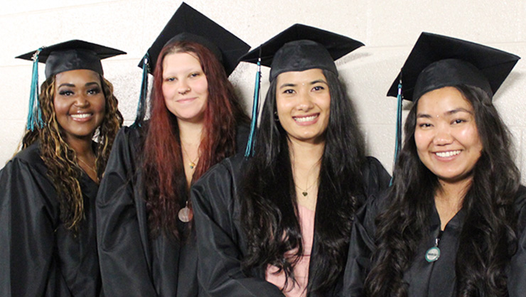 Four female students at Commencement