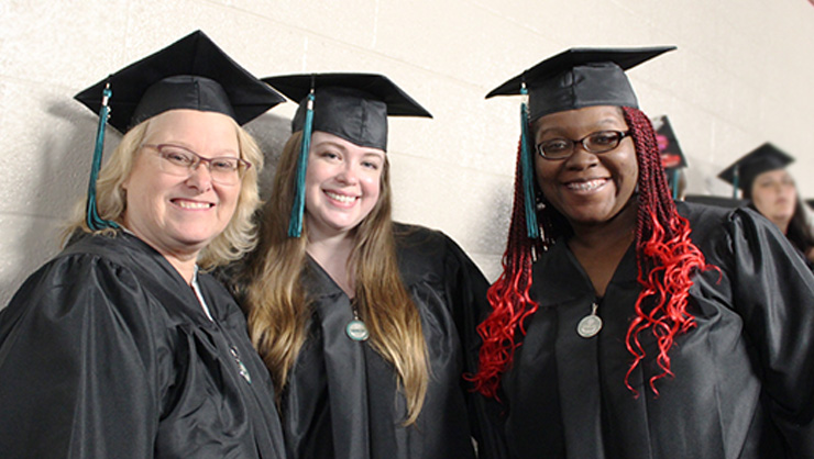Three female students at Commencement