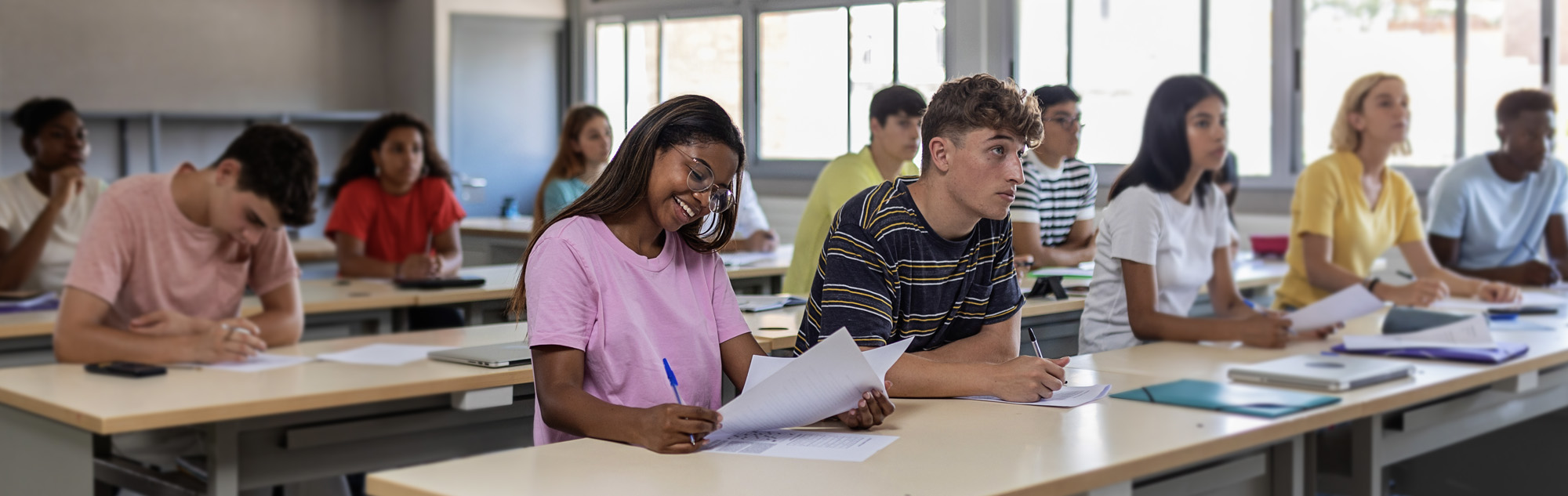 Classroom with students listening to professor.