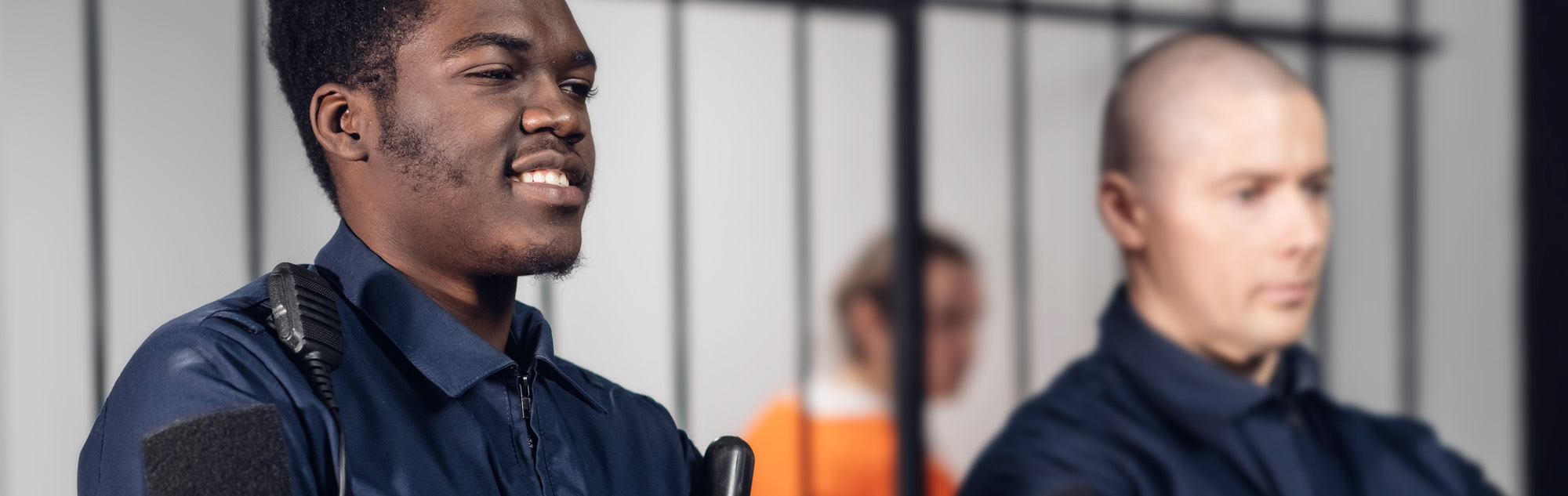 Two correctional officers stand guard.