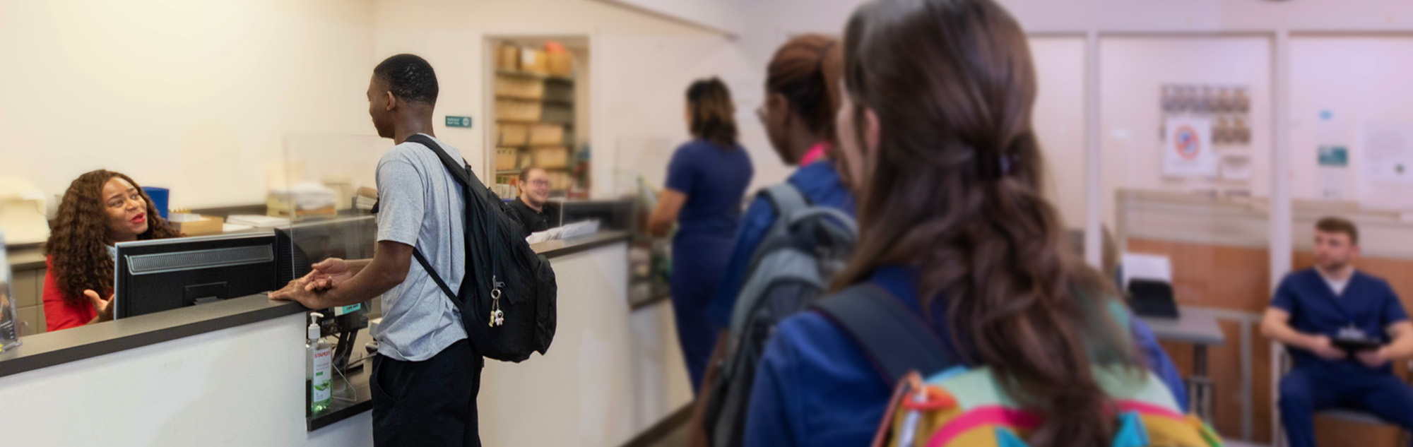 Students stand in line to talk to Financial Aid staff.