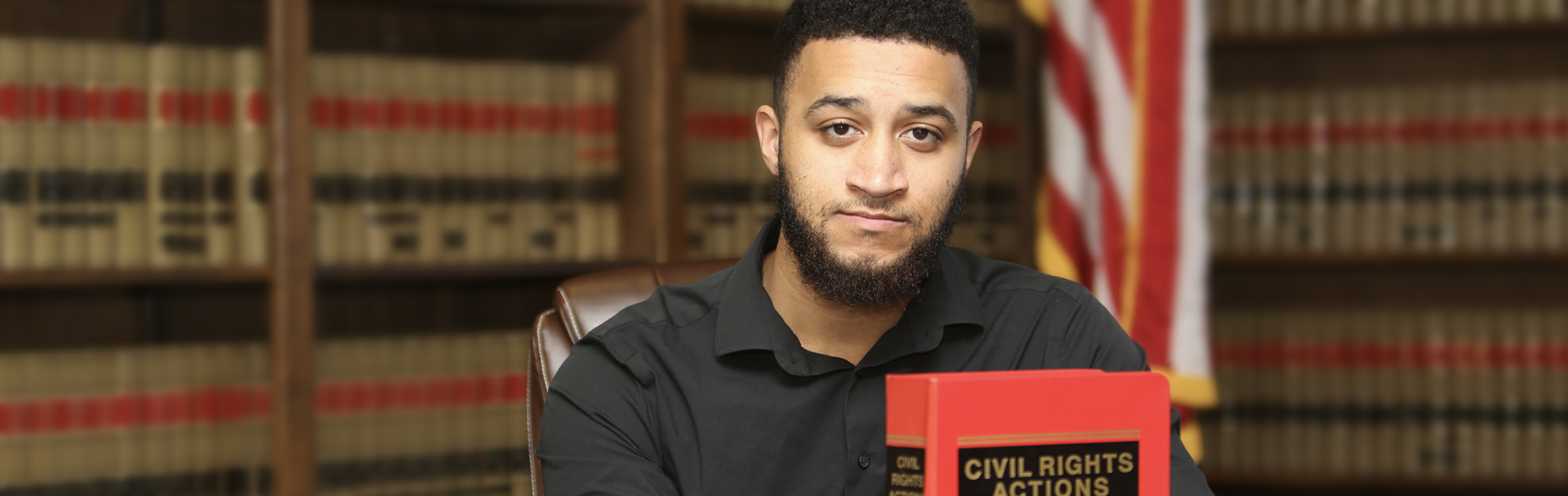 Man examines law books.