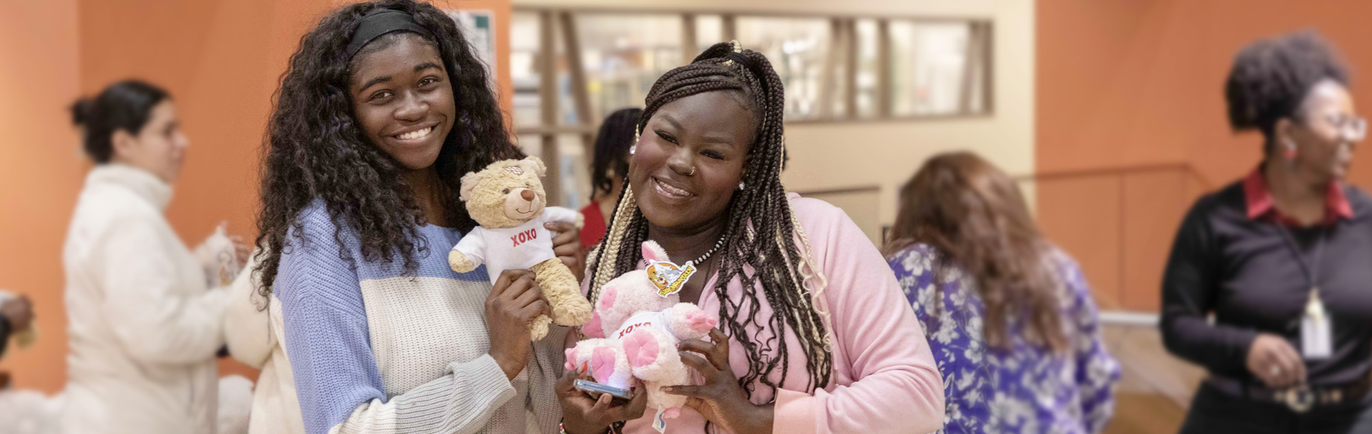 Students pose with build-a-valentine stuffed animals at the Southeast campus.