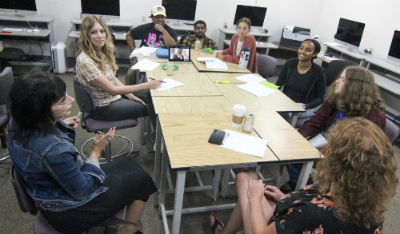 Students in Pam Esposito's Graphic Design III class host Amqui Station Farmers Market Manager Denise Pullella for a discovery meeting. 