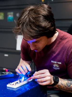 Back on the White Bridge campus, Jacob Pickos, a computer science major, is constructing a programmable 8-bit computer as part of an honors project.